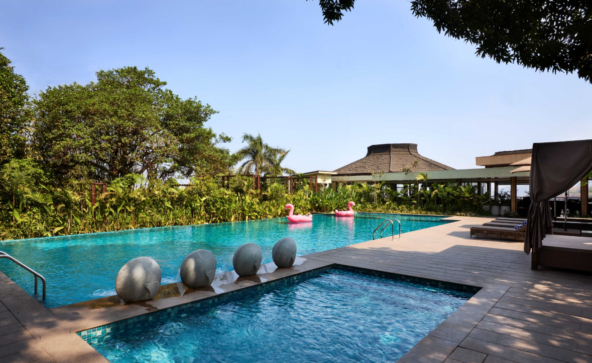 Chalet Hotels Launches ATHIVA Hotels & Resorts with Six PropertiesBody:
Chalet Hotels Limited (CHL) has announced the launch of ATHIVA Hotels & Resorts, a new premium lifestyle hospitality brand with over 900 keys across six hotels. The name ATHIVA is derived from the Sanskrit word for “abundance” and “to a great extent.” The brand focuses on joy, sustainability, and wellness, aiming to combine reliable hospitality with thoughtful experiences.The first property under the brand is ATHIVA Resort & Spa, Khandala, created through the transformation of The Dukes Retreat. The resort has 147 rooms, including 11 suites, and emphasizes local experiences and sustainable practices.Five additional properties will transition to ATHIVA over time. These include a renovated business hotel in Navi Mumbai, The Resort at Aksa Beach (a K Raheja Corp Group hotel), and three greenfield projects under development—two in Goa and one in Thiruvananthapuram. CHL plans to double the brand’s capacity within three years.ATHIVA is designed for evolving traveller preferences, offering features such as Breakfast@Anytime, Binge Box complimentary snacks, Dollops of Joy surprise treats, and Local Immersions for cultural engagement. Each property will incorporate energy-efficient design, waste-conscious operations, local sourcing, and community partnerships as part of Chalet’s Parivartan initiative.